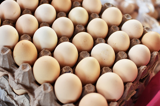 Woman buys eggs in the supermarket. Egg store supermarket price expensive grocery shop concept