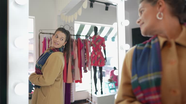 Mature woman trying on clothes in a thrift store