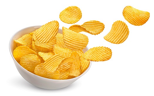 Falling ridged potato chips in bowl isolated on white background with clipping path