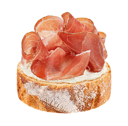 Italian prosciutto crudo sandwich, spanish jamon on rye bread slice, serrano ham bruschetta isolated on white background