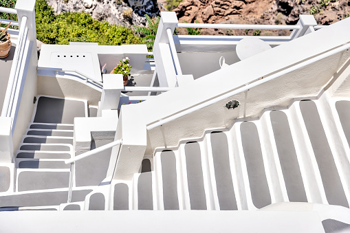 Fira, Greece - July 20, 2023: Walkways and staircases in the town of Fira on the island of Santorini in Greece