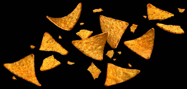 istock Falling corn chips, hot Mexican nachos isolated on black background 1653571016
