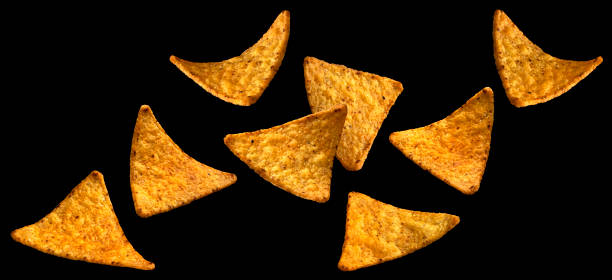 istock Falling corn chips, hot Mexican nachos isolated on black background 1653572121
