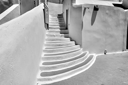Fira, Greece - July 20, 2023: Walkways and staircases in the town of Fira on the island of Santorini in Greece