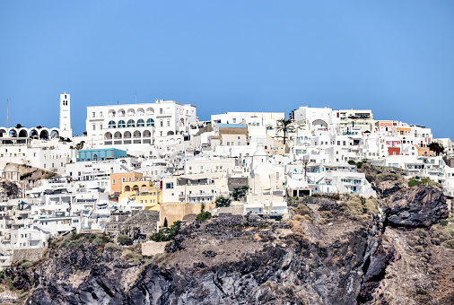 Fira, Greece - July 20, 2023: Cliffside buildings and walkways in the town of Fira on the island of Santorini in Greece