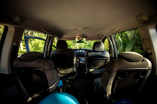 Empty interior of a minivan car with luggage ready to travel. Assembling the car for a road trip. View from the inside of the car without people but with packed luggage..