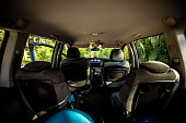 Empty interior of a minivan car with luggage ready to travel. Assembling the car for a road trip. View from the inside of the car without people but with packed luggage.
