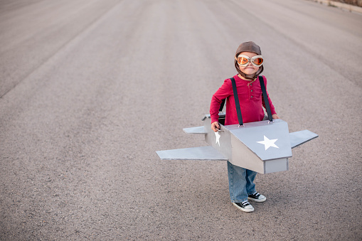 A young boy is ready to pilot himself into his dreams. He is wearing a homemade jetpack.
