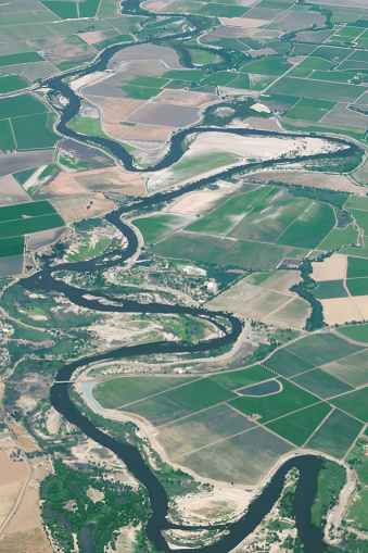 terrain of a water resource winding through a plain in the central valley