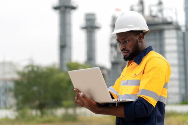 Accomplished African American engineer who exemplifies the future of remote power plant control and capacity optimization. Operates a laptop computer, a powerful tool for managing the intricate systems of a modern power plant. Accomplished African American engineer who exemplifies the future of remote power plant control and capacity optimization. Operates a laptop computer, a powerful tool for managing the intricate systems of a modern power plant. Minimize waste and embrace a Zero Waste future project manager remote stock pictures, royalty-free photos & images