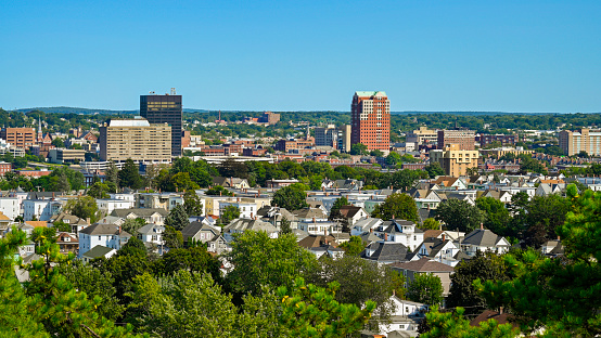 Manchester city skyline and clear blue sky with commercial buildings and residential houses in New Hampshire, USA