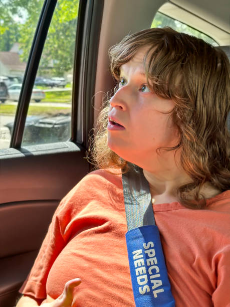 istock Disabled young woman looks out car window 1653775988