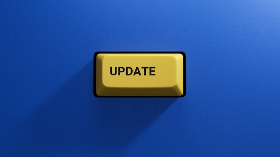 update.3D illustration of button of keyboard of a modern computer.Light yellow button.3D rendering on blue background.