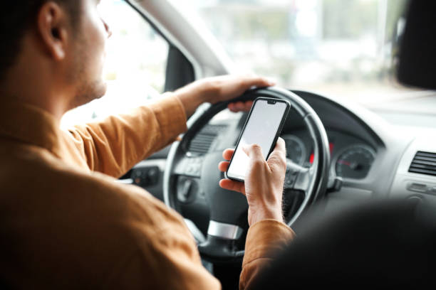 istock Rear view of man text messaging while driving car in the city 1653821339