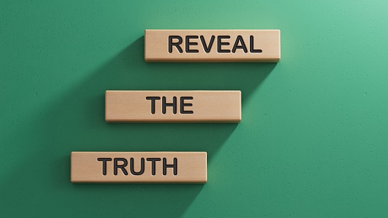 Reveal the truth symbol. Concept word Reveal the truth on wooden blocks. Business and Reveal the truth concept. Copy space.3D rendering on green background.