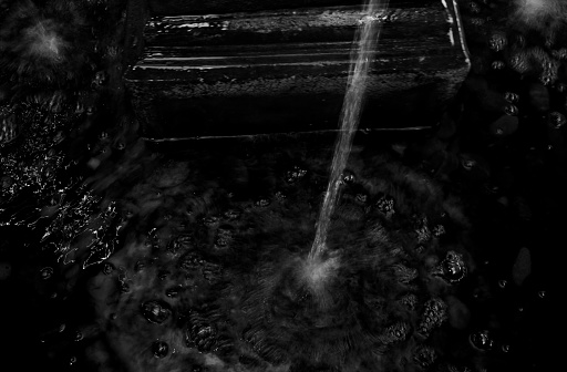Water fountain in motion blur and black and white