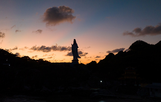 Silhouette photo of the Avalokiteshvara Buddha statue at dawn, Kien Giang province, southwest coast of Vietnam