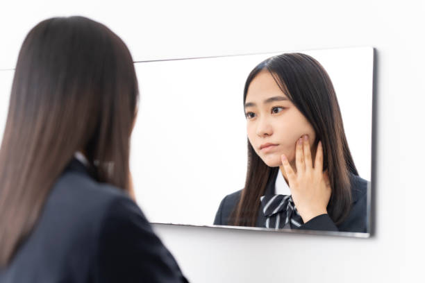 istock A female student looking in the mirror. 1653961655