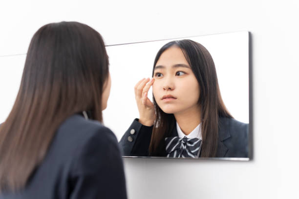 istock A female student looking in the mirror. 1653961657