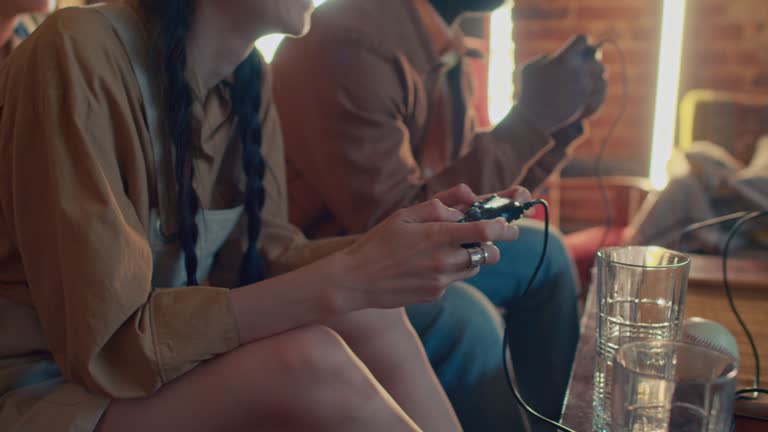 Young Man And Woman Playing Console Game