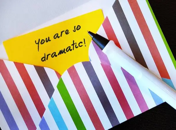 Pen and handwriting note YOU ARE SO DRAMATIC! gaslighting way to accuse or emotional abuse others to question their beliefs or doubt their perception and become distressed