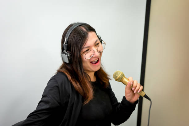 istock Woman (LGBTQ) singer sing a song with microphone 1654066500