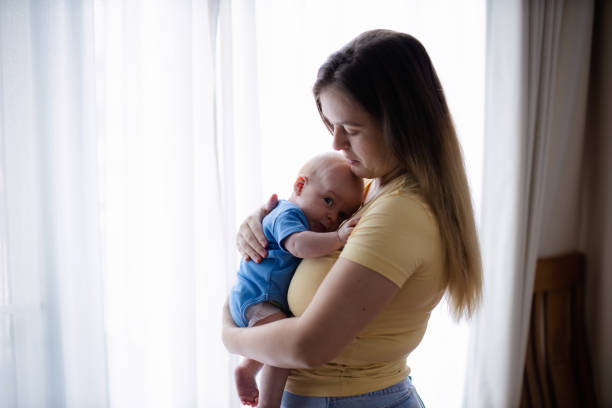 istock Young mother with a newborn baby 1654075628