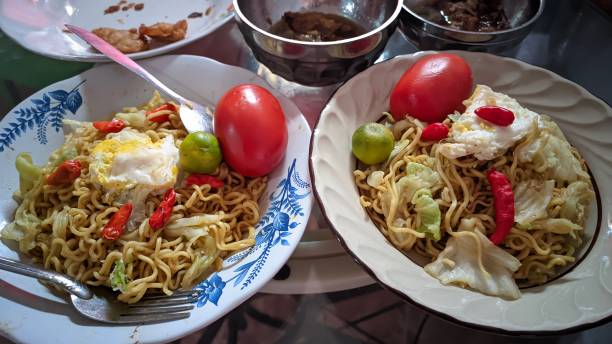 istock A special fried noodle dish with a simple topping design containing sliced ​​cabbage, tomatoes, chilies and lime 1654081718