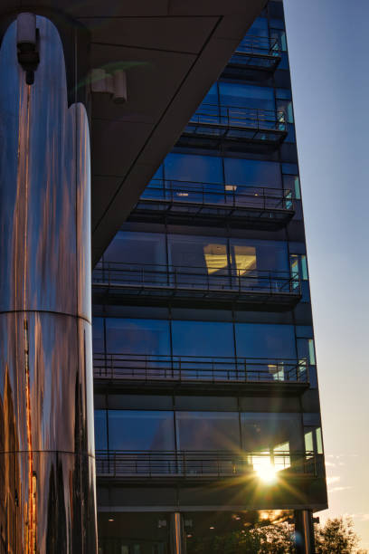 Early morning sun shining through office block window, Leeds, West Yorkshire, England, Britain
