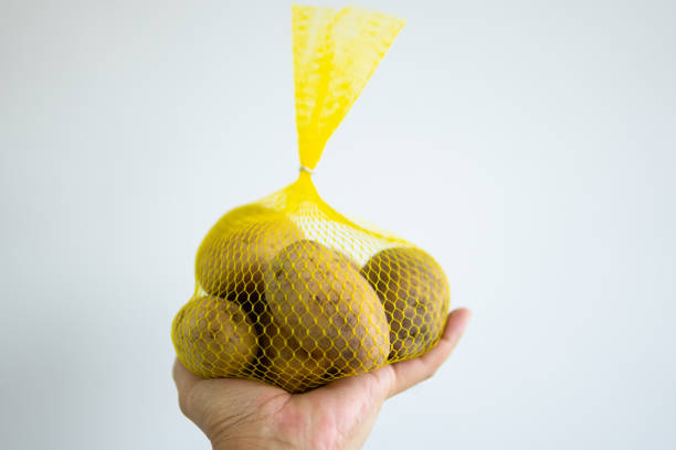 istock Close up hand holding potato 1654144561