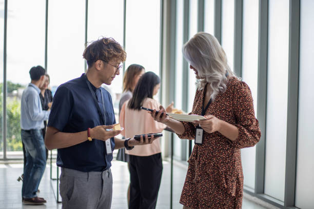 istock businessmen/woman walking and talking 1654148476