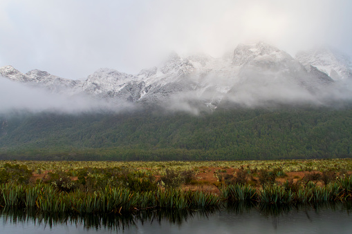 Photograph of snow on a large mountain range in Fiordland National Park on the South Island of New Zealand