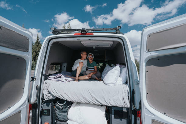 istock Happy senior couple relaxing on camper van bed 1654167890