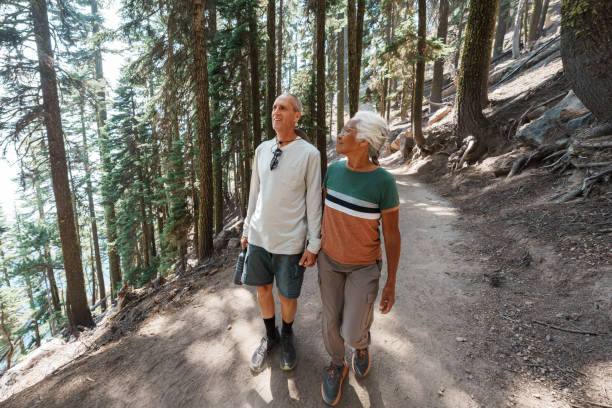 istock Active retired couple on mountain hike through forest 1654168067