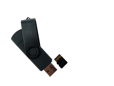 Black USB pen drive with memory card isolated on white.