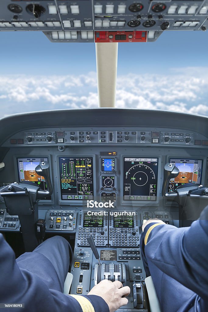 Cockpit Pilots in the cockpit during a commercial flight Cockpit Stock Photo