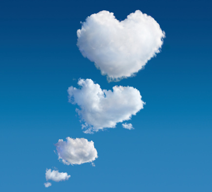 Clouds against blue sky becoming bigger and bigger and finally in the shape of heart.