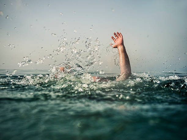Drowning Hand reaching out of deep water, focus on water splash drowning photos stock pictures, royalty-free photos & images
