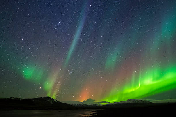 istock Northern lights against starry sky and silhouette mountains 165418508