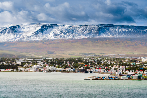 view to akureyri and the snow covered mountains behind, it is the biggest city in northern iceland