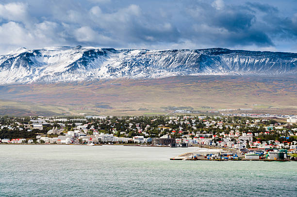 akureyri, iceland view to akureyri and the snow covered mountains behind, it is the biggest city in northern iceland akureyri stock pictures, royalty-free photos & images