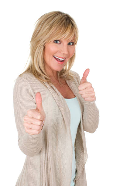 beautiful mature woman gesturing two thumbs up as success concept