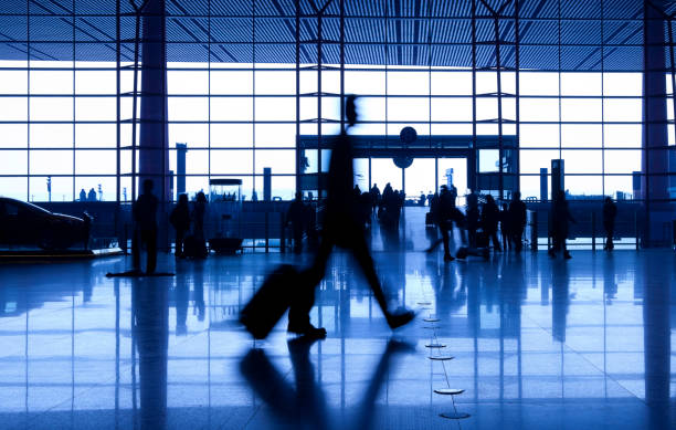 istock People silhouettes at airport building 165418864