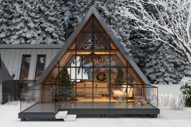 modern chalet in winter with christmas decoration. living room with christmas tree and gift boxes. snow covered trees on background - ski resort winter snow night imagens e fotografias de stock