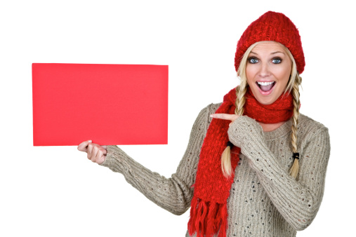 Cute woman holding a red sign for copy space and isolated on white