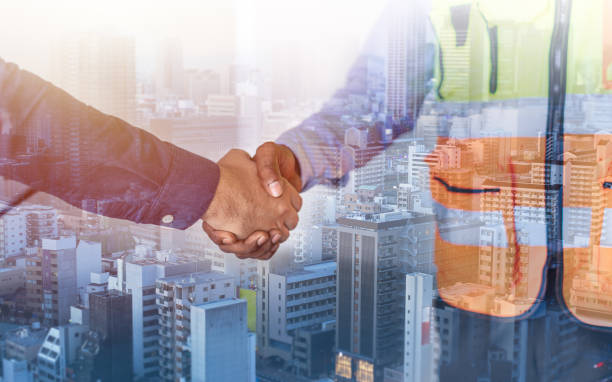 istock Construction engineer business handshake builder with investor for successful of project deal and modern city background, architect teamwork cooperate partnership concept. 1654227450