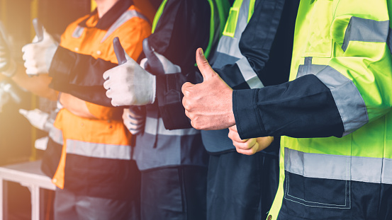 closeup hand of engineer worker team standing together thumbs up for good like positive agree gesture