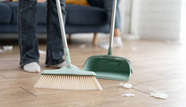 istock Unknown maid sweep up construction debris with a brush in a dustpan at home 1654232952