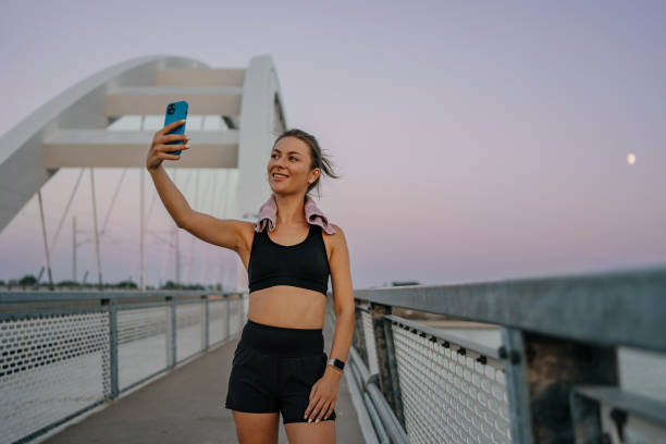 istock Young woman takes out her mobile device 1654253509