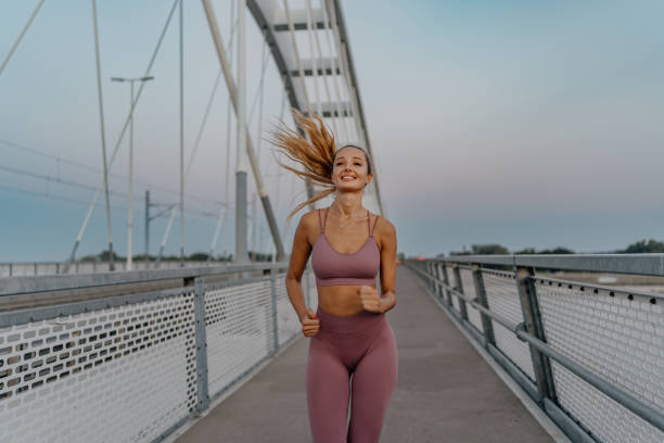istock Determined young woman maintains her pace during a bridge run 1654255093